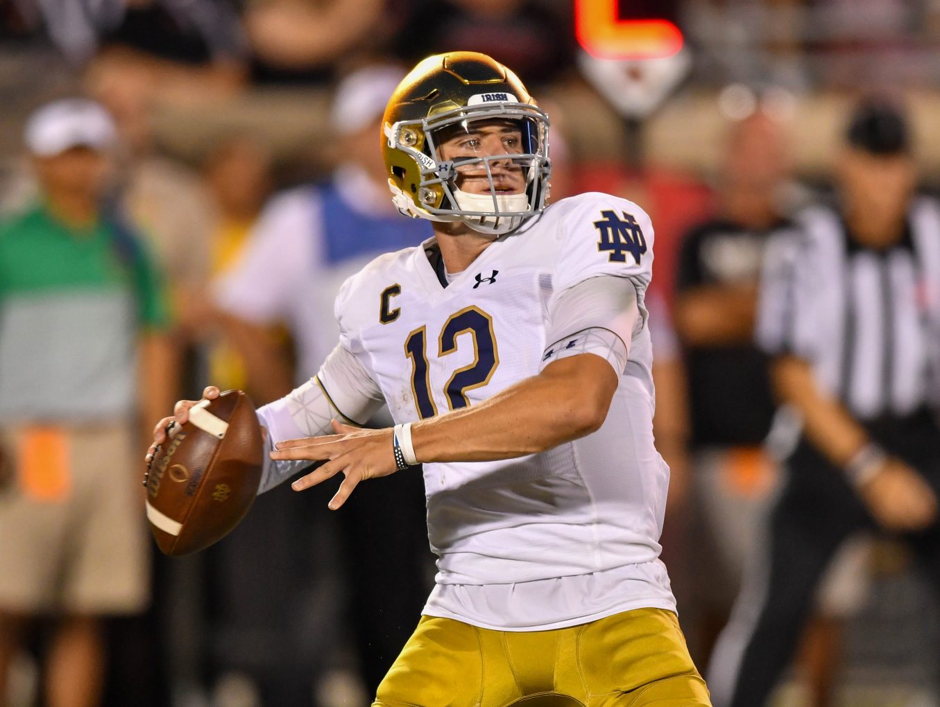 Notre Dame QB Ian Book&apos;s pass hits Louisville cheerleader in face on sideline