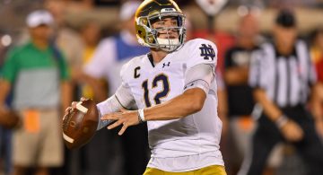 Notre Dame QB Ian Book&apos;s pass hits Louisville cheerleader in face on sideline